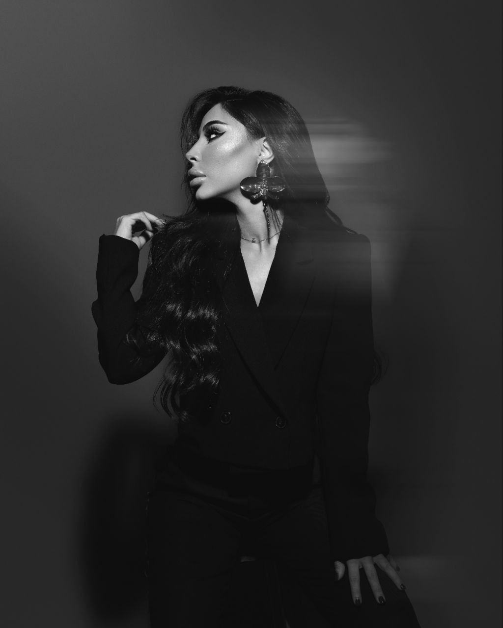 Black and white studio portrait of Zina Almokri in profile